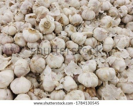 top view on a bunch of raw garlic in local market. This photo contain slight noise and selective focus.