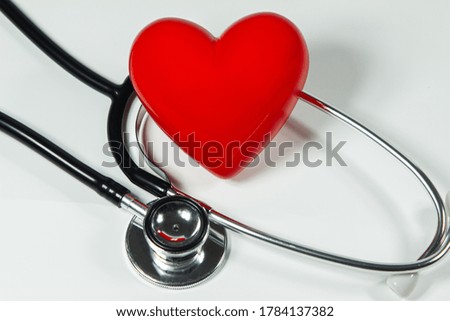 Red heart and a stethoscope on isolated white background.
