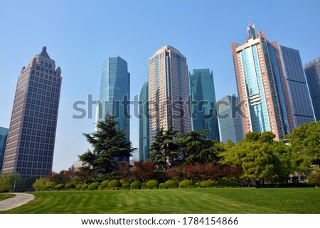 different colorful skyscrapers under blue sunny day in Lujiazui Park in Pudong of Shanghai 