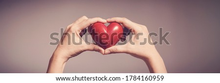 Woman holding red heart, health insurance, donation, happy charity volunteer concept, world mental health day, world heart day, self care, CSR, csv concept Royalty-Free Stock Photo #1784160959