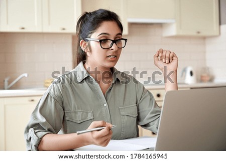 Indian woman online teacher, student, remote worker video conference calling, watching webinar training working learning at home office. Female tutor giving webcam online class zoom lesson on laptop. Royalty-Free Stock Photo #1784165945