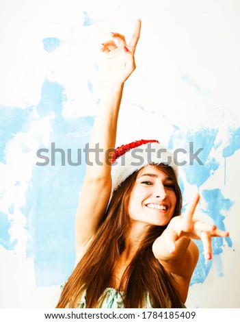 young pretty happy smiling woman on christmas in santas red hat posing isolated on white background, lifestyle people concept