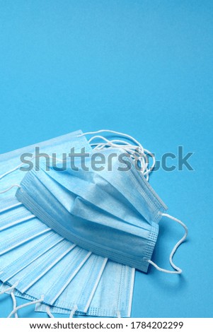 Disposable blue medical face mask on blue background