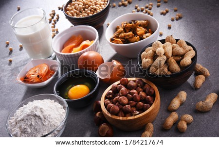 Composition with common food allergens including egg, milk, soya, peanuts, hazelnuts, fish, seafood and wheat flour Royalty-Free Stock Photo #1784217674