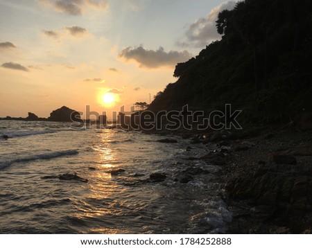 Beautiful sunset with sea and rock