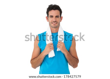 Portrait of a fit young man with towel standing over white background