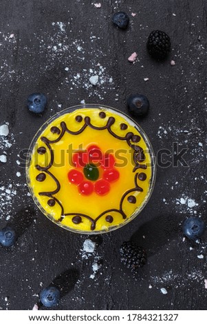 yellow jelly with a pattern on a dark background, flat lay