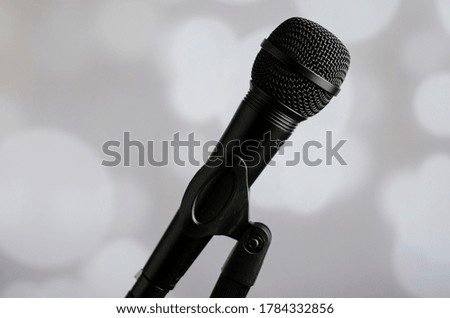 black microphone with white bokeh background
