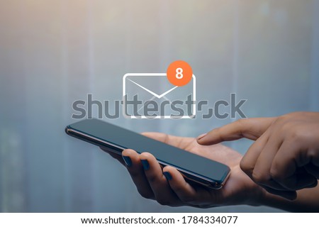 Businesswoman hand using smartphone on table in office with 8 new email alert sign icon pop-up. Mail communication connection message technology. Royalty-Free Stock Photo #1784334077