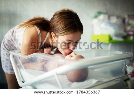 Picture of happy mother playing with sweet baby girl