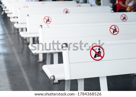 Selective focus at white plastic bench on ferry boat transport. With sign guideline for social distance concept to protect and prevent from Coronavirus Pandemic. Public transportation, New normal. 