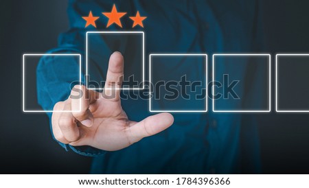 Business people use the index finger to touch the virtual screen to select the starred icons, future digital technology working in digital form, business strategy concepts, human business concepts. Royalty-Free Stock Photo #1784396366
