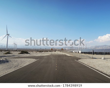 End of the road with a view of wind turbines in the wilderness