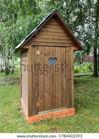 Wooden village toilet in Russia. Heart-shaped window. Royalty-Free Stock Photo #1784402393