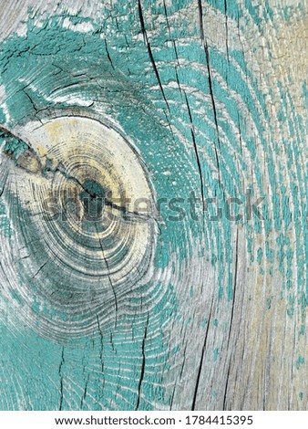 
background image of an old cracked wooden surface with shabby blue marine paint