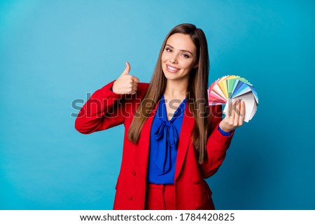 Nice choice. Photo of attractive professional lady interior designer hold palette cards hands raise thumb up wear luxury red suit blouse shirt isolated blue color background