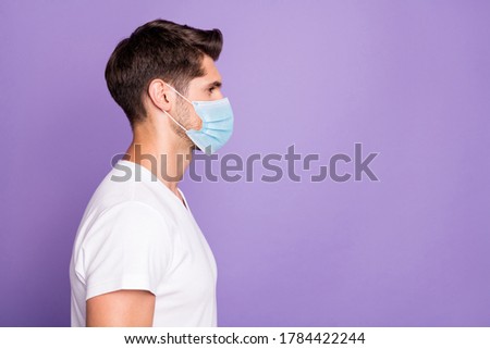 Profile side view portrait of his he nice attractive healthy guy freelancer modern haircut copy space wearing safety mask isolated bright vivid shine vibrant lilac violet purple color background Royalty-Free Stock Photo #1784422244
