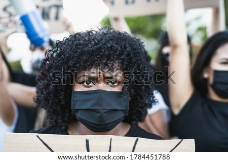 Young Afro woman activist protesting against racism and fighting for equality - Black lives matter demonstration on street for justice and equal rights