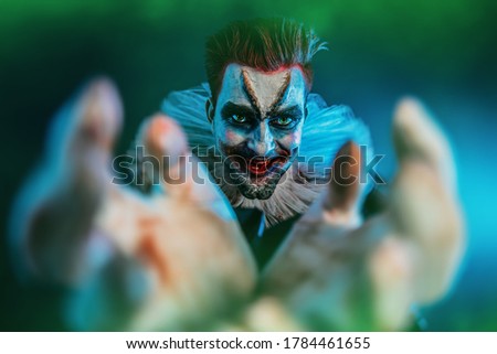 A portrait of an angry crazy clown from a horror film. Halloween, carnival.