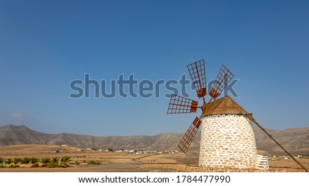 
Old windmill on Fuerteventura island with the desert mountains in the background
