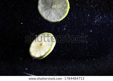 Water drops on ripe sweet lemon. Fresh lime  background with copy space for your text. Vegan and vegetarian concept.