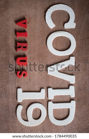 Block letters of Covid19 Virus  on wooden background.Coronavirus and Covid-19 Concept.