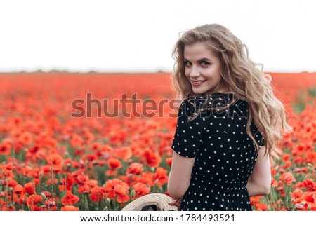 Beautiful woman natural face blondie hair casual female portrait  in red poppy field in hat