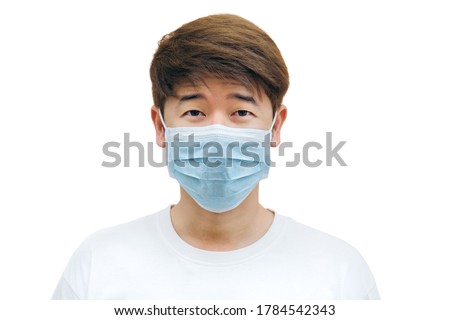 Close up of young Asian man wearing face mask against the corona virus, covid-19 with isolated white background. Royalty-Free Stock Photo #1784542343
