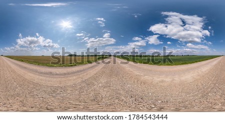 Full spherical seamless hdri panorama 360 degrees angle view on no traffic white sand gravel road among fields with clear blue sky and beautiful clouds in equirectangular projection, VR AR content