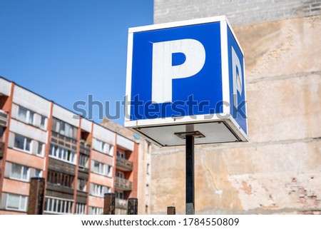 Parking sign. Apartment houses, urban environment. Sunny day and blue sky