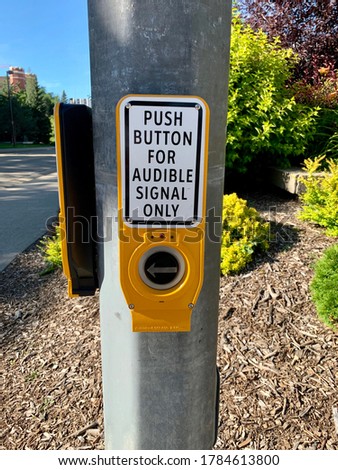 Push button for audible signal crosswalk sign to ensure pedestrians with visual impairments cross safely