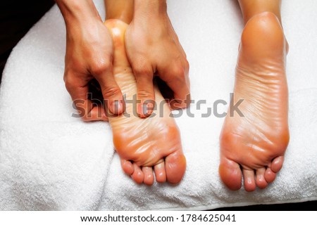 Female feet close up. Photo of massage of legs and feet. Male hands of a masseur.
