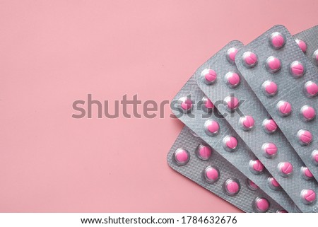 Top view of blister pack on pink background 