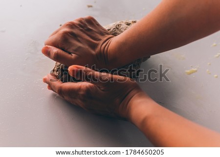 woman hands kneading dough for making bread