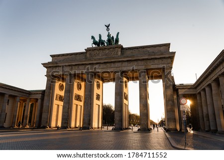 The famous monument Brandemburg Gate in Berlin shot in sunset light. Translation of the sign: Free (transit)
