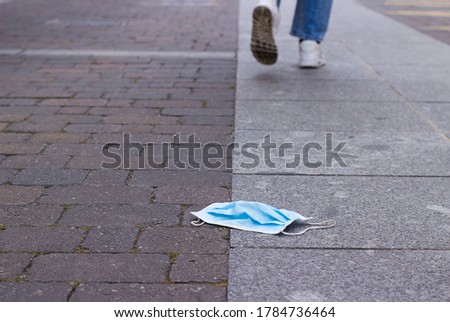 steps away from a surgical mask lying on the floor. selective focus Royalty-Free Stock Photo #1784736464