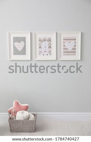 Stylish baby room interior with cute pictures on wall