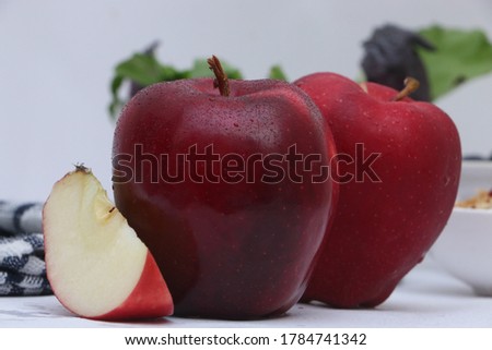 Fresh Juicy Red Delicious Apple placed in White background.
