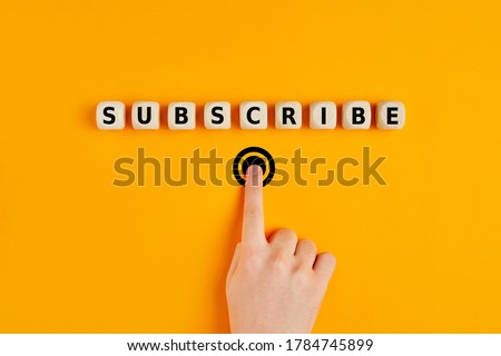 Male hand pressing subscription button with the word subscribe written on wooden blocks. Online registration concept. Royalty-Free Stock Photo #1784745899