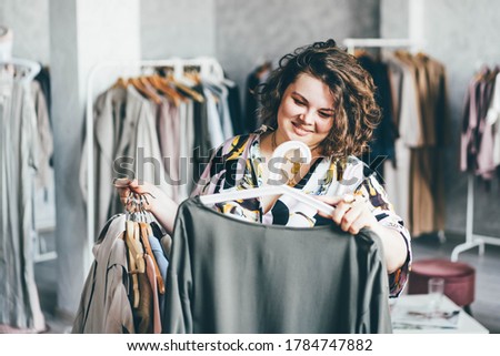  Plus Size Woman Choose Fashioned Dress in Store. Plus size women shopping. Royalty-Free Stock Photo #1784747882