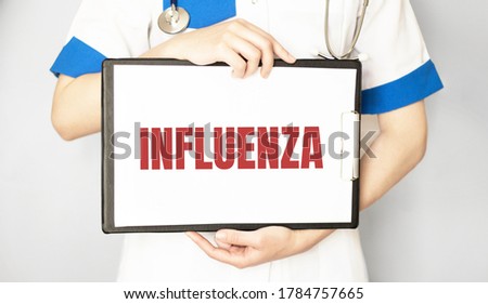Doctor holding a card with text INFLUENZA,medical concept