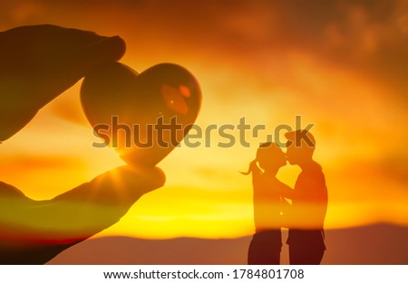 Man, and woman kissing next to heart. Couple, love and relationship concept.  Royalty-Free Stock Photo #1784801708