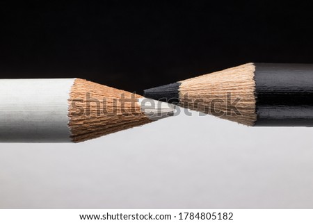 White and black pencils. Contrast and opposite concept Royalty-Free Stock Photo #1784805182