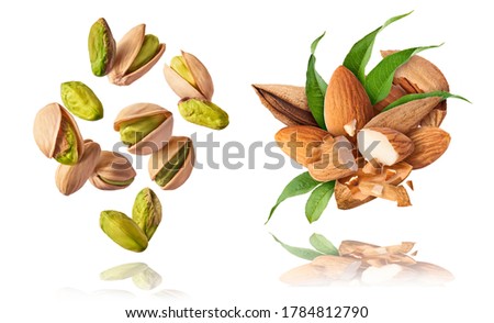 A set with Flying in air fresh raw whole and cracked pistachios and almonds isolated on white background. Concept of Pistachios is torn to pieces close-up. High resolution image