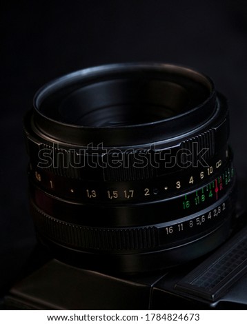 Vintage SLR lens on black background