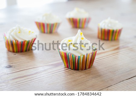 Cupcakes with lemon sprinkles on a wooden table