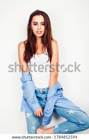 young pretty stylish brunette hipster girl posing emotional isolated on white background happy smiling cool smile, lifestyle people concept