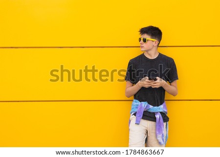 teenager on the city street with mobile phone 