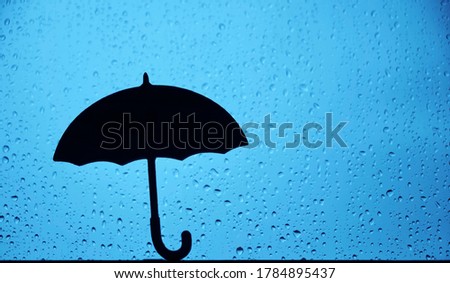 Window with raindrops. sign, symbol of umbrella. rainy weather.
