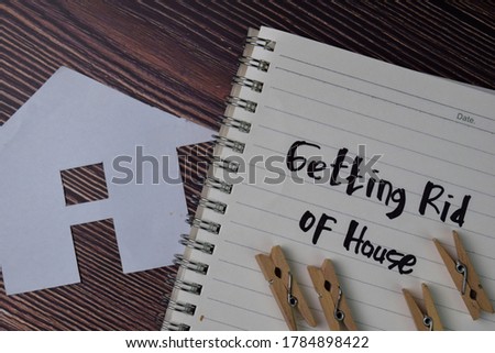 Getting Rid of House text write on a book isolated wooden table.